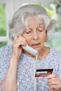 Senior Woman Giving Credit Card Details On The Phone